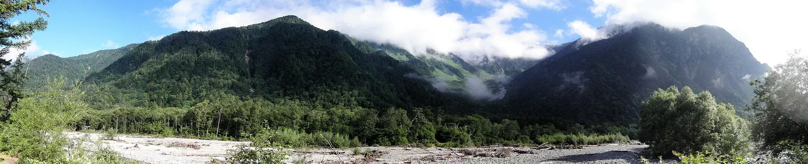 Cloud over forested Japanese Alps valley at Kamikochi
