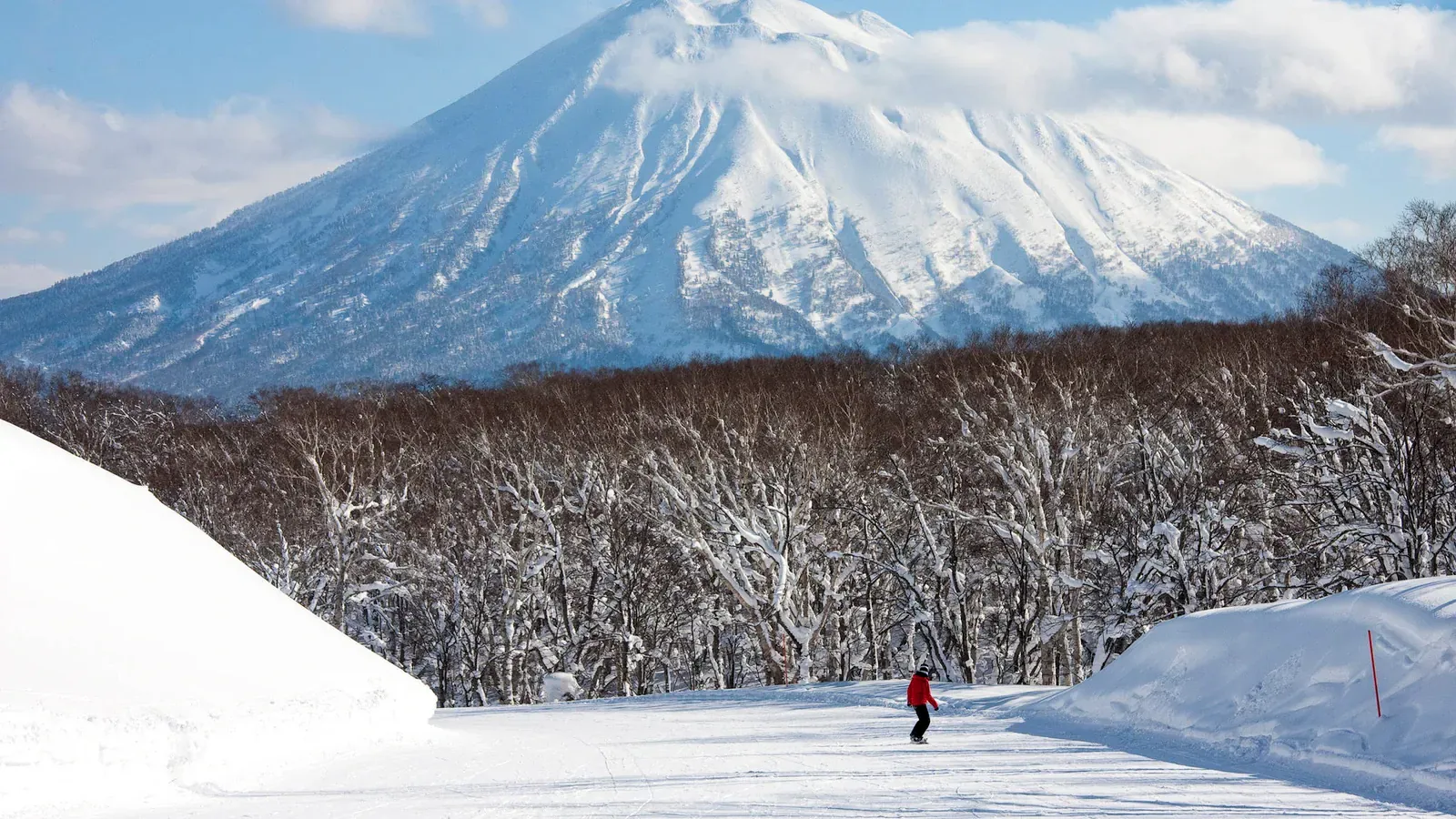 Snow-capped Mount Yotei above a groomed Niseko ski run